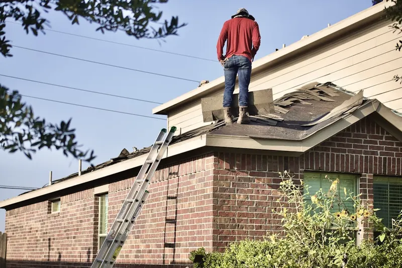 Professional roofer working on a residential roof in Scholar Woods